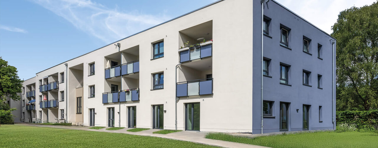 Ein modernes Gebäude in Bielefeld mit hellen Balkonen bietet eine gepflegte außerklinische Wohngemeinschaft.